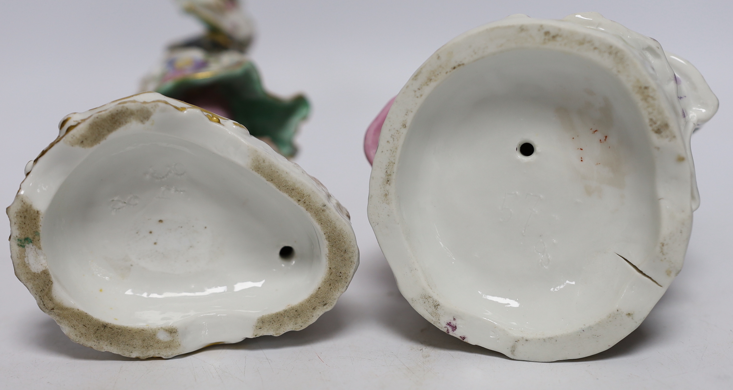 A pair of Continental porcelain figures wearing 18th century dress, largest 24cm high